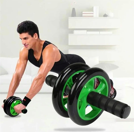 Man using green and black ab roller wheel for core workout at home