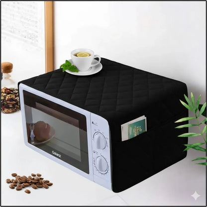 Black quilted microwave cover with side pocket, protecting white Galanz microwave in kitchen setting