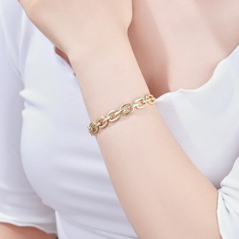 Gold chain link bracelet on woman's wrist, elegant everyday jewelry accessory